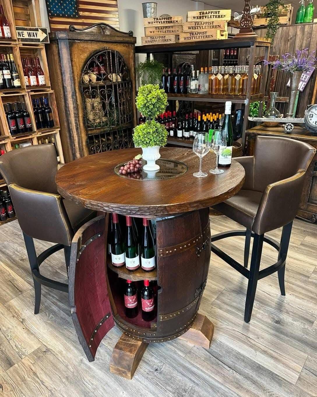 Bar table made from an old wine barrel with a round wooden top, wine bottles stored inside the opened barrel, two leather bar stools beside it
