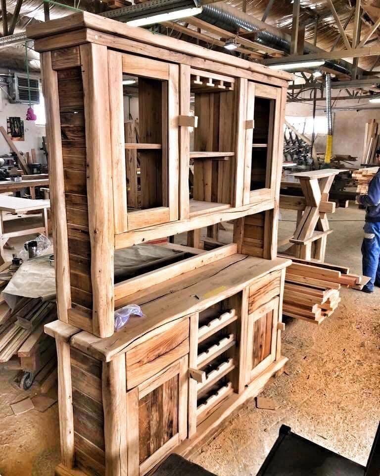 The same buffet cabinet further along: side panels, shelves and the wine bottle rack are in place, the wood is still untreated