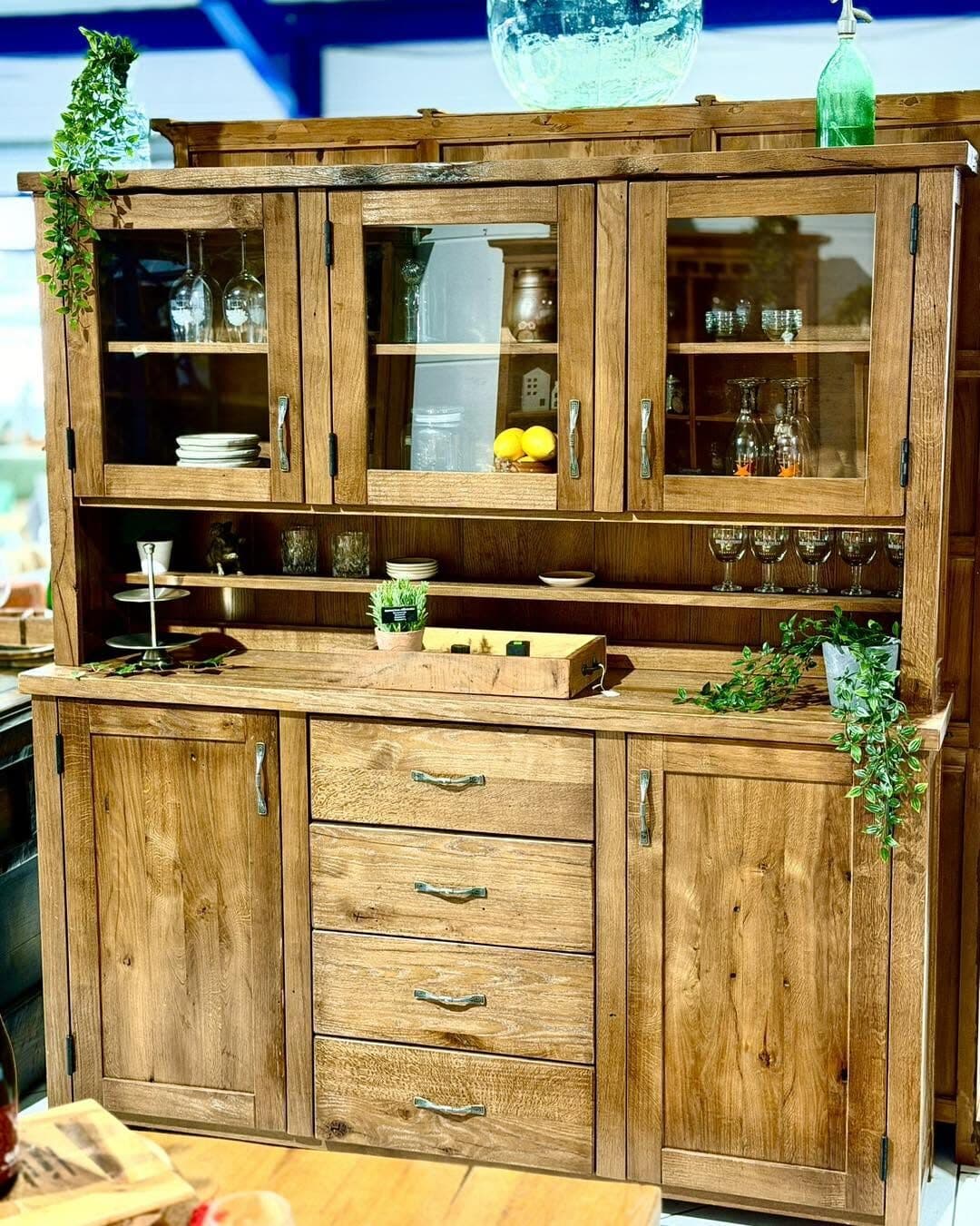 Large light oak buffet with four glass doors, four drawers and an open middle section