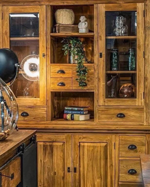 Detail of a teak highboard with glass doors, small drawers and open compartments